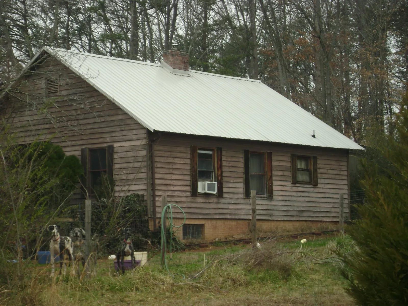 White metal roof on an old wood sided farmhouse, from a Metal Roof Installation job in Newton